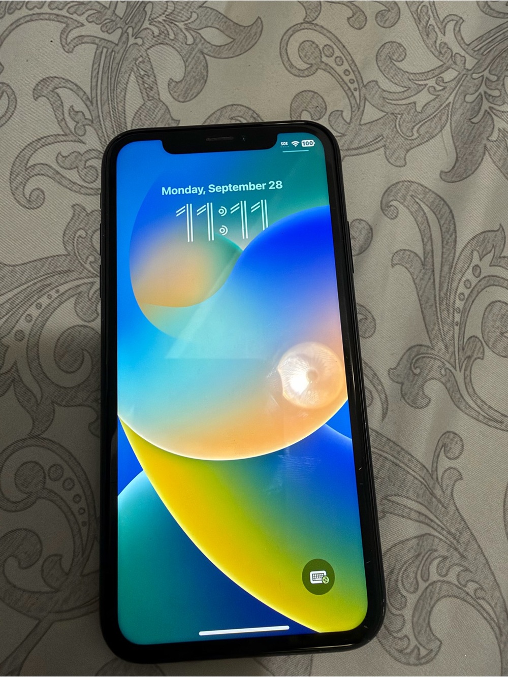 Apple iPhone with Black Case and Multicolor Display